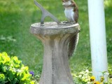 Squirrel sits upon sundial...